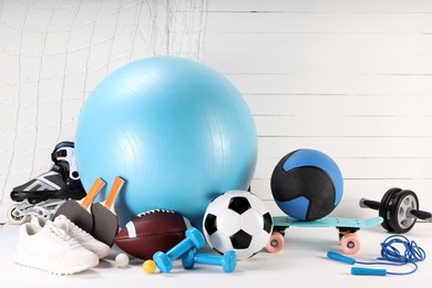 Photo of Many different sports equipment on white table