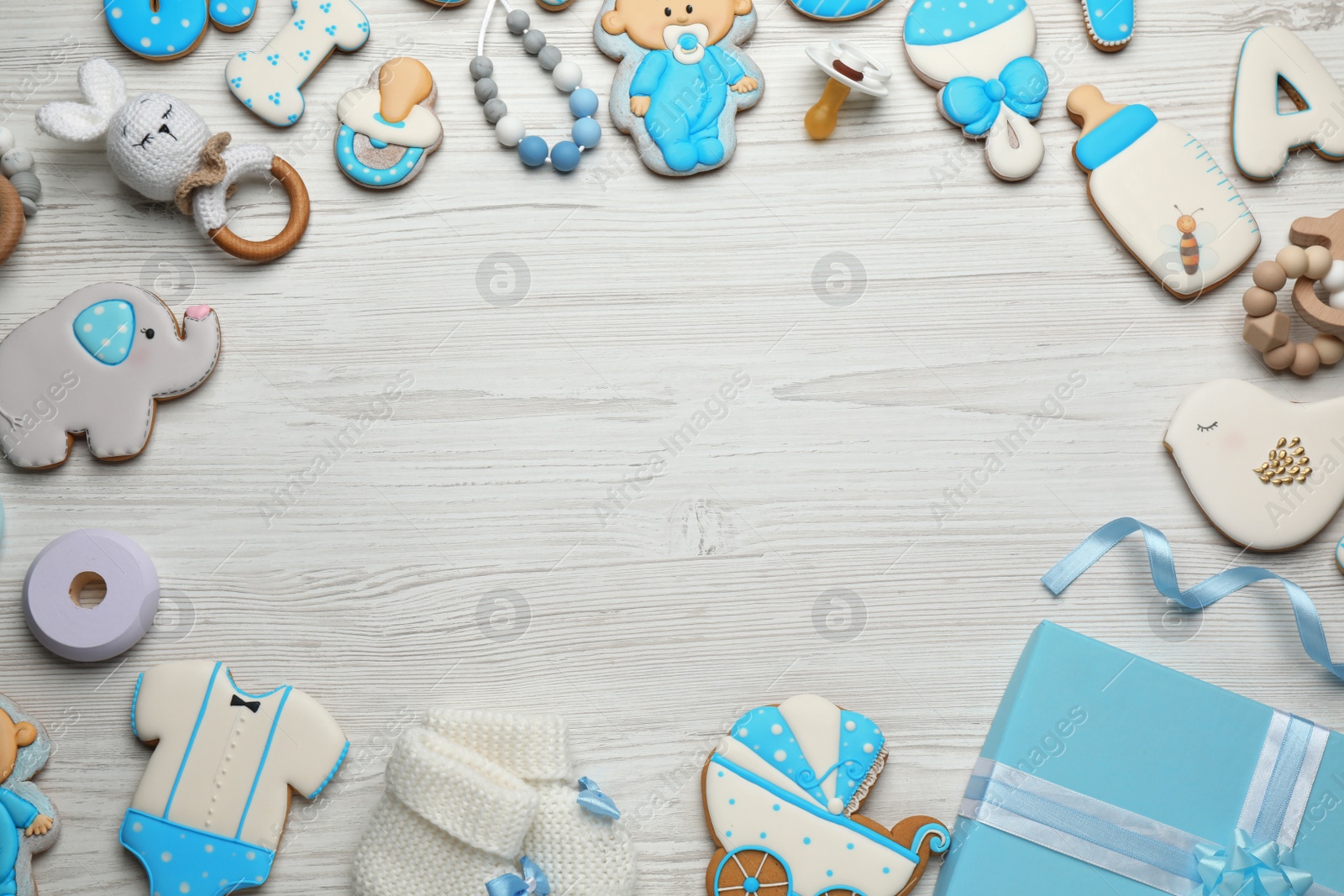 Photo of Frame made with cute tasty cookies of different shapes, flat lay and space for text. Baby shower party