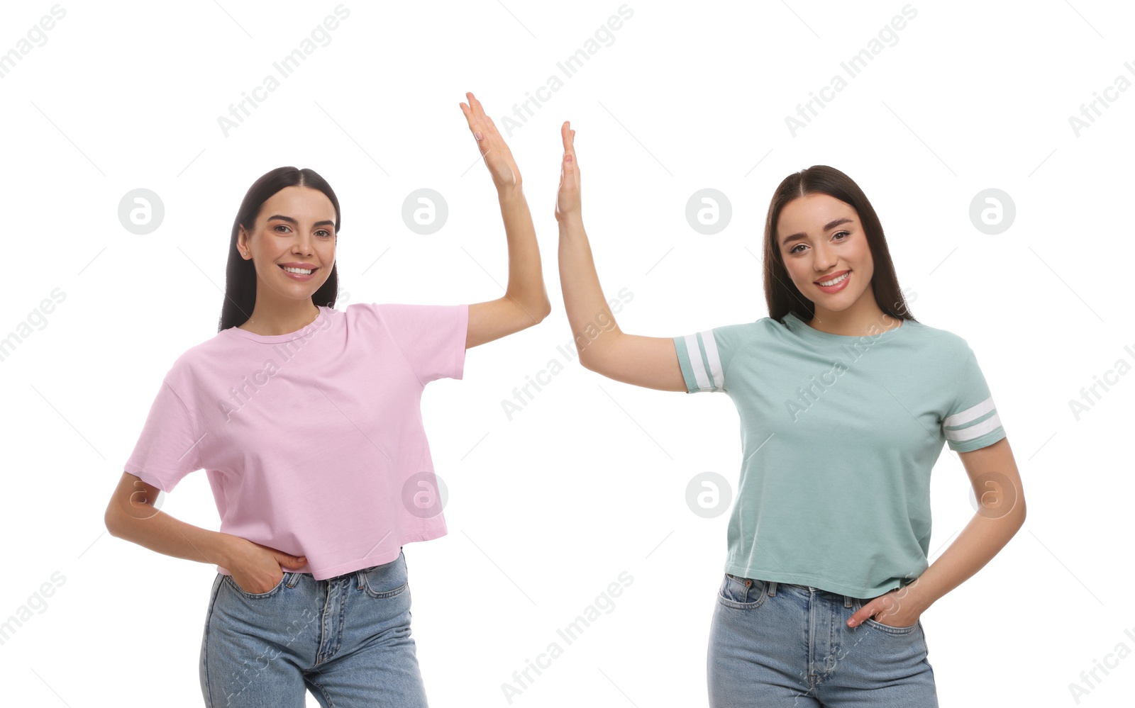 Photo of Women giving high five on white background