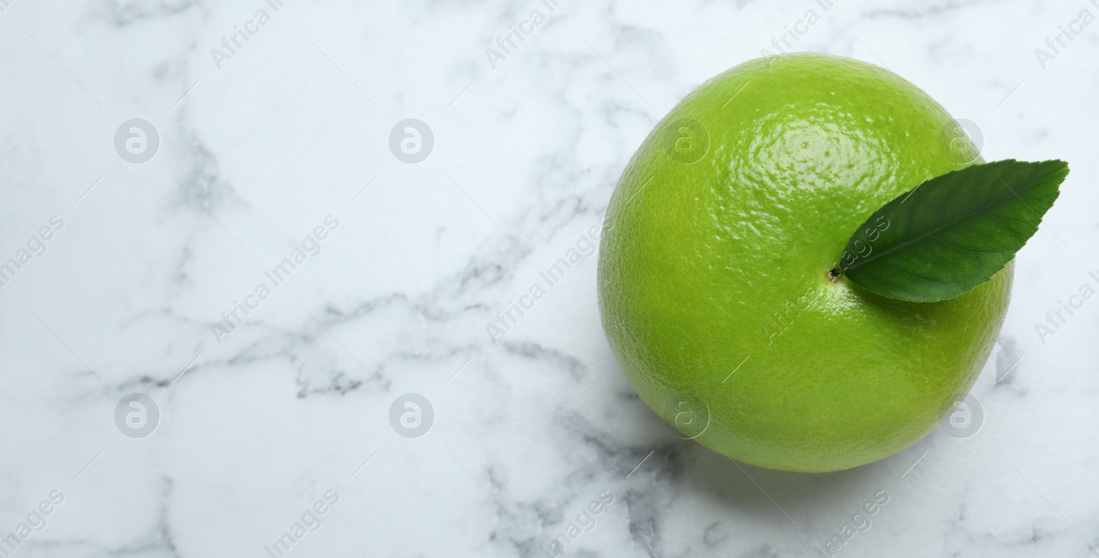 Photo of Fresh ripe sweetie fruit on white marble table, top view. Space for text