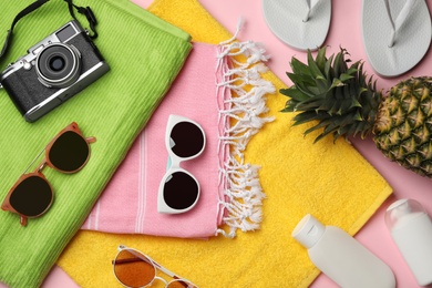 Flat lay composition with beach accessories on color background