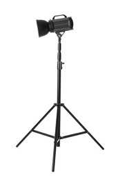 Photo of Studio flash light on tripod against white background. Professional photographer's equipment