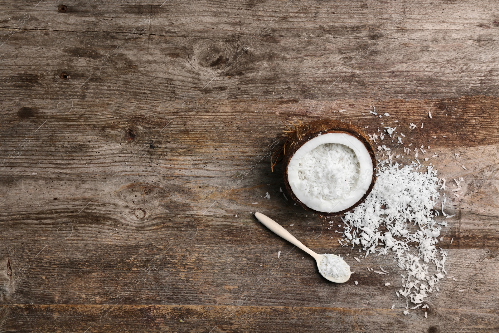 Photo of Composition with fresh coconut flakes on wooden background, top view