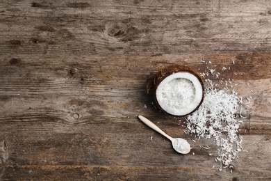 Composition with fresh coconut flakes on wooden background, top view