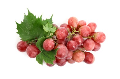 Photo of Cluster of ripe red grapes with green leaves on white background, top view