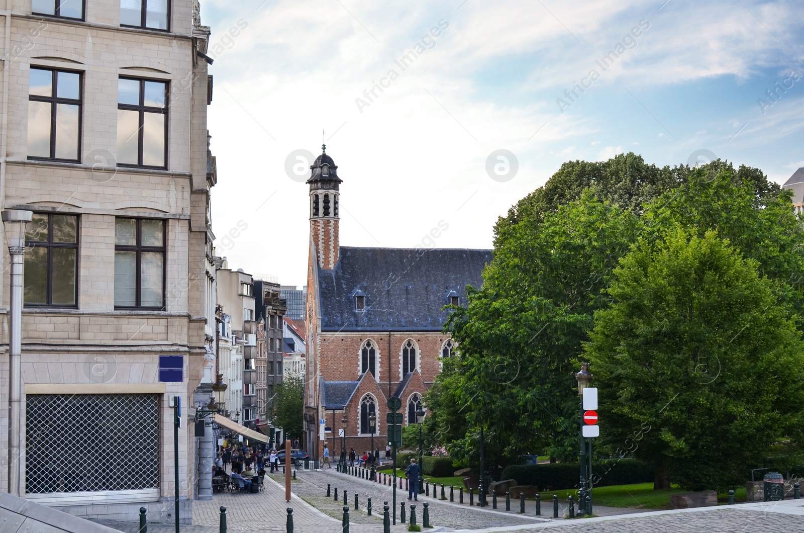 Photo of City street with beautiful buildings and green trees