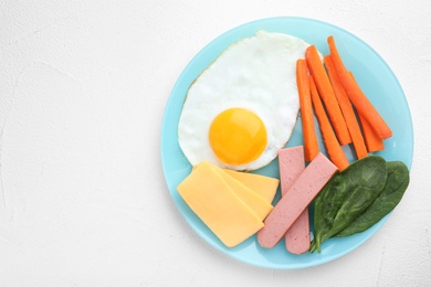 Plate with healthy breakfast on white table, top view. Space for text