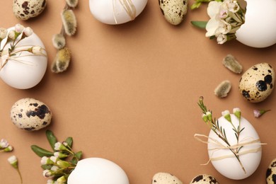 Photo of Frame made of eggs and natural decor on brown background, top view with space for text. Happy Easter