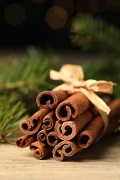 Photo of Bunch of cinnamon sticks on wooden table, closeup