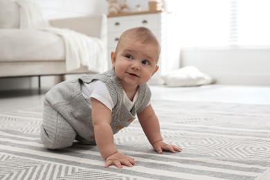 Photo of Cute baby crawling on floor at home