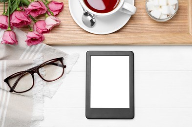 Flat lay composition with modern e-book reader on white wooden table