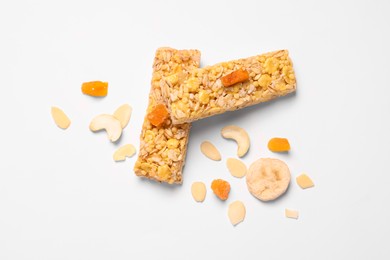 Tasty granola bars and ingredients isolated on white, top view