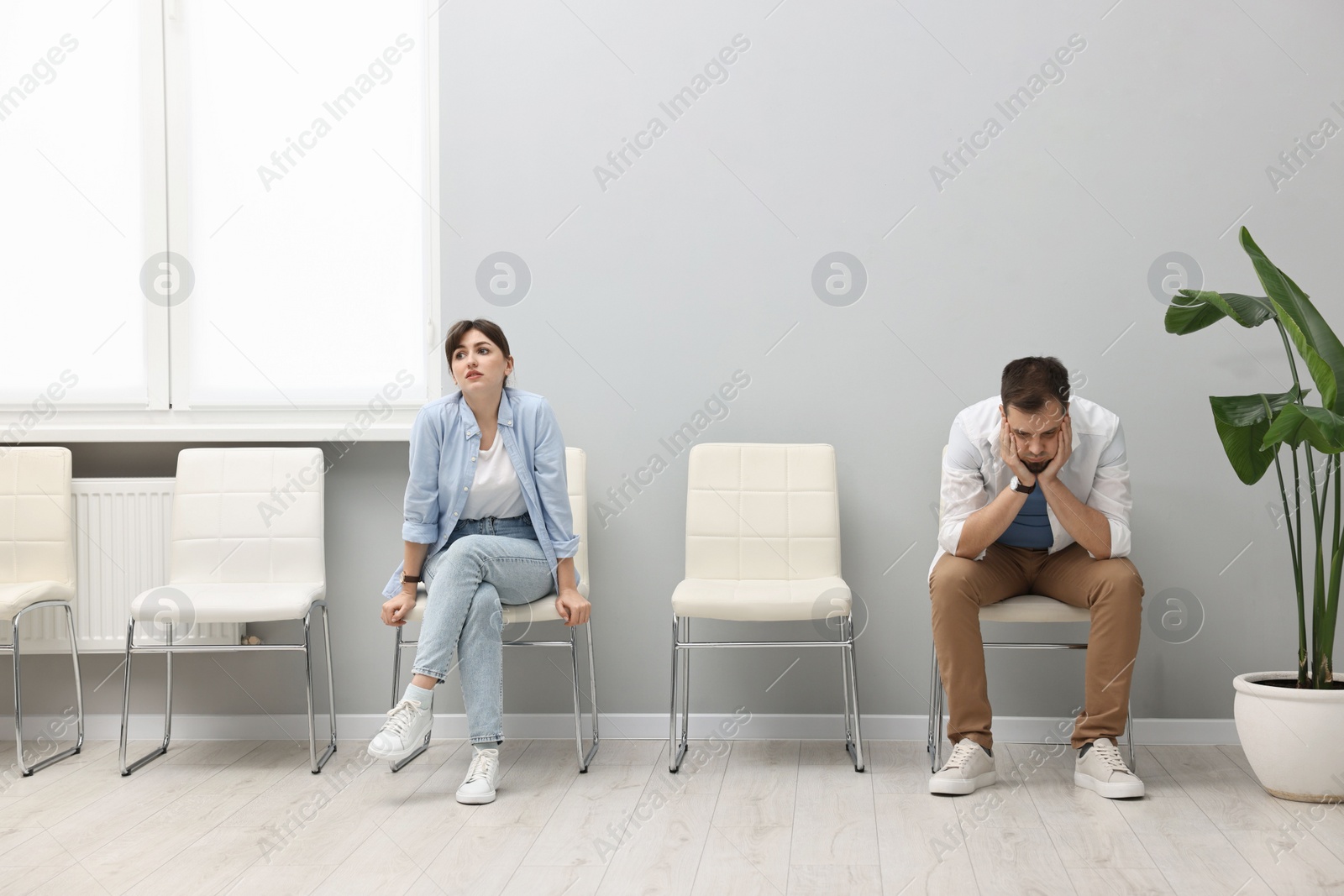 Photo of Man and woman waiting for appointment indoors