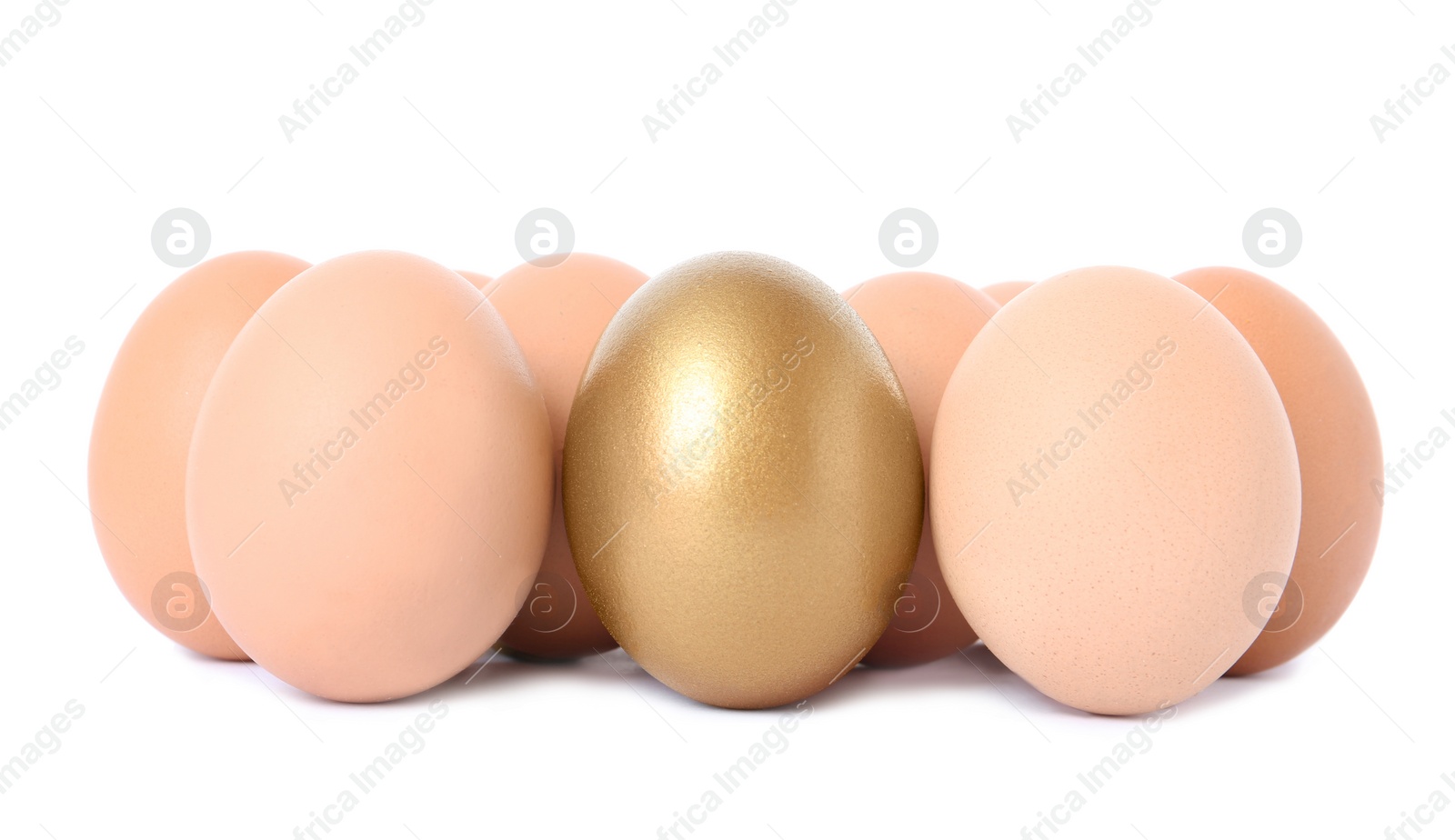 Photo of Golden egg among others on white background