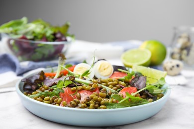 Plate of salad with mung beans on white marble table