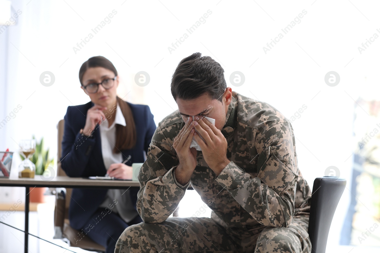 Photo of Psychotherapist working with male military officer in office