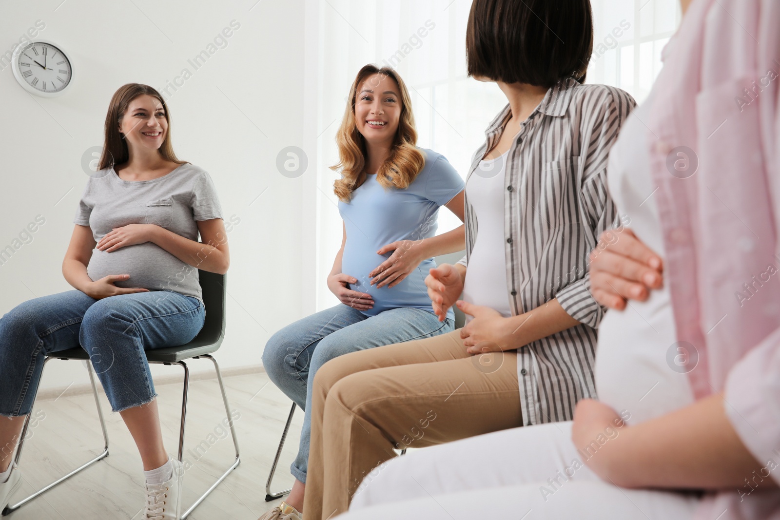 Photo of Group of pregnant women at courses for expectant mothers indoors