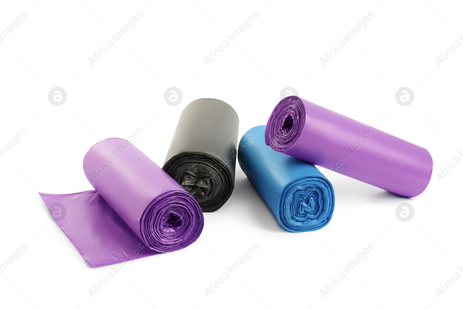 Photo of Rolls of different garbage bags on white background. Cleaning supplies