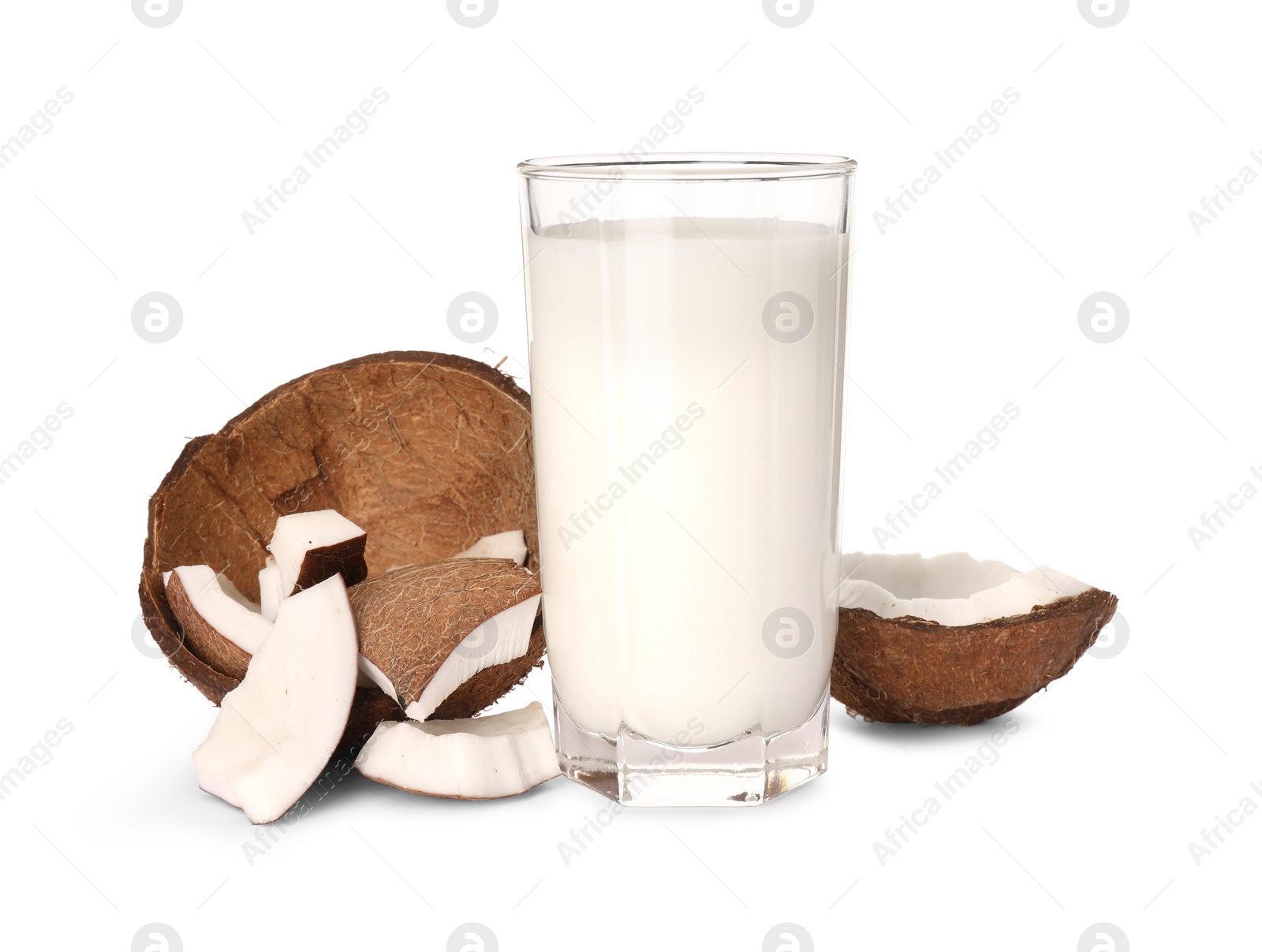 Photo of Glass of delicious vegan milk and coconut pieces on white background