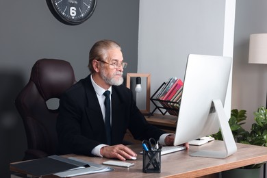 Photo of Successful senior boss working in his office