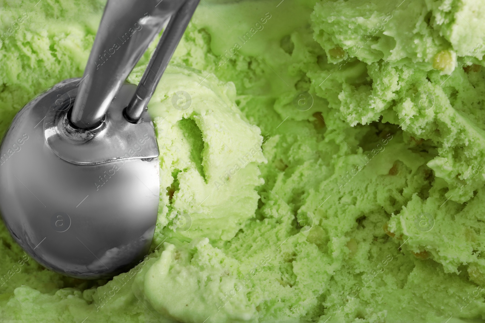 Photo of Delicious pistachio ice cream with scoop as background