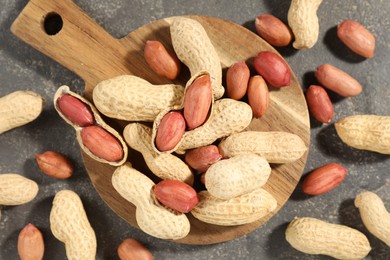 Photo of Fresh unpeeled peanuts on grey table, top view