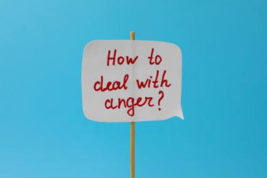 Photo of Paper speech bubble with inscription How To Deal With Anger? on light blue background