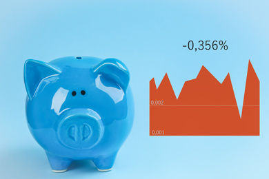 Cute piggy bank and graph on light blue background