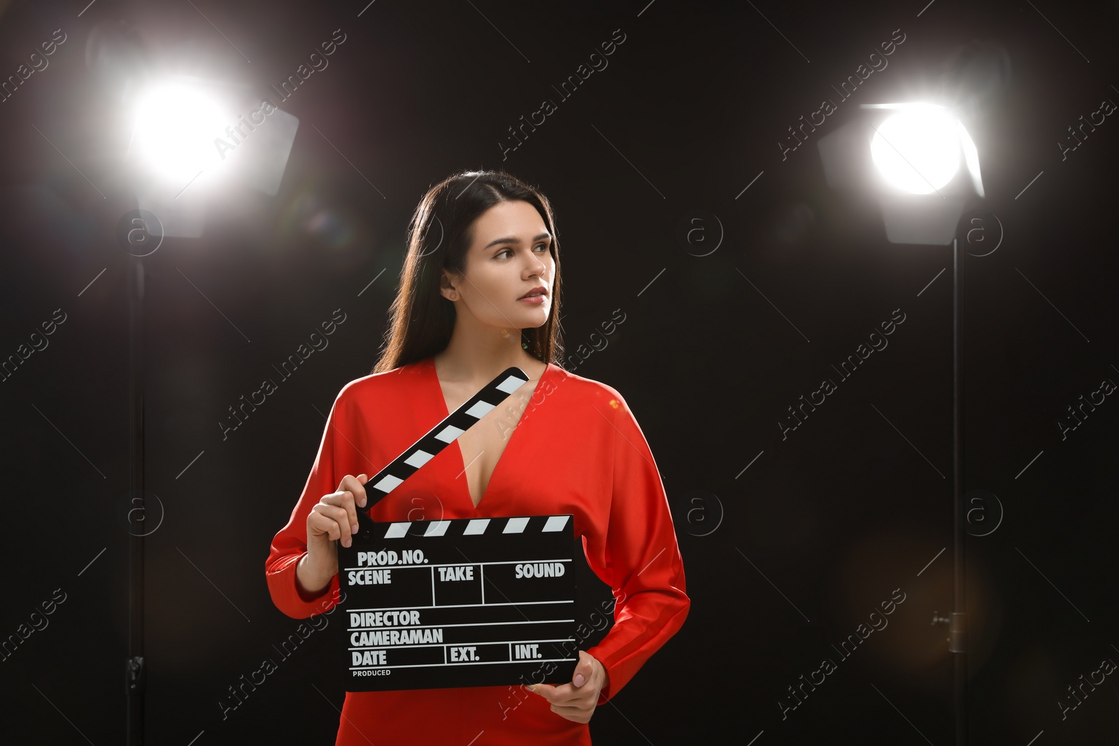 Photo of Actress with clapperboard on stage. Film industry