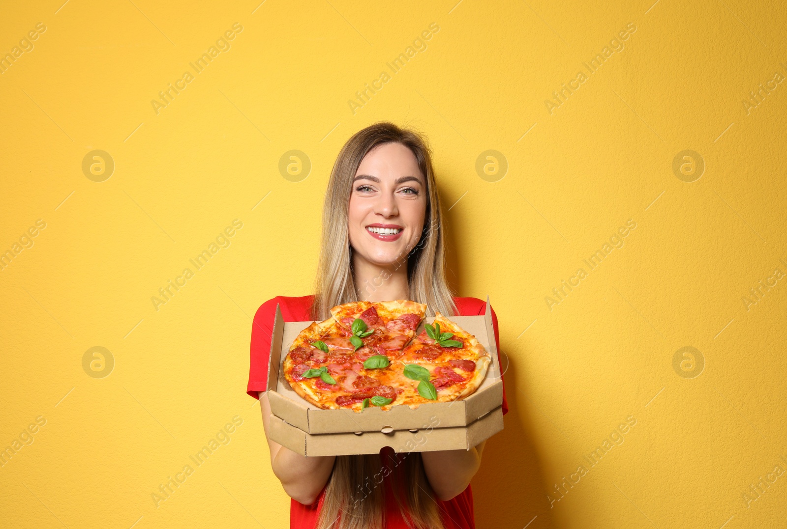 Photo of Attractive young woman with delicious pizza on color background