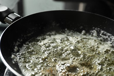 Photo of Melting butter in frying pan on table, closeup