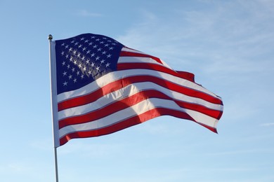 Photo of American flag fluttering outdoors on sunny day