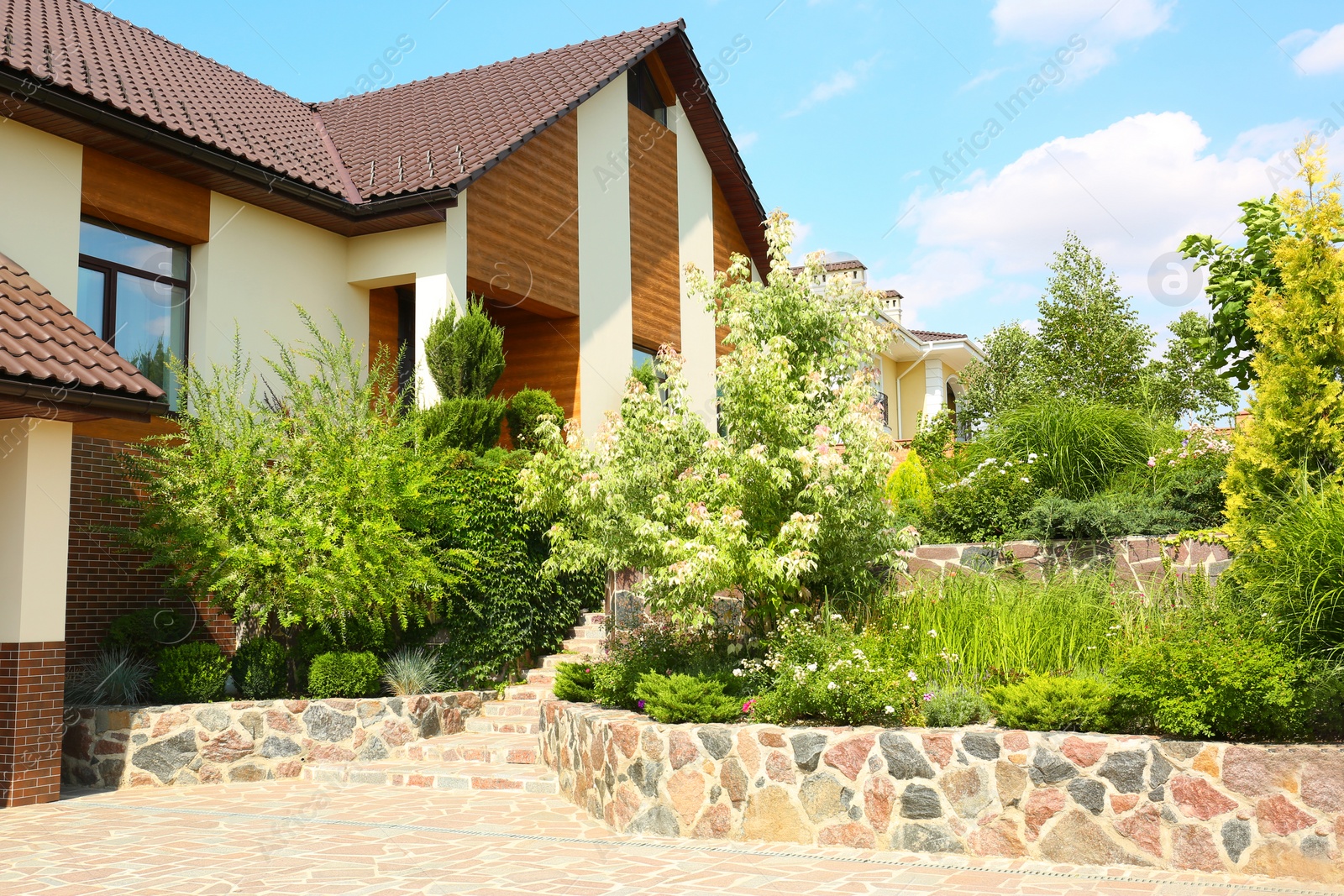 Photo of Landscape with modern house and beautiful garden on sunny day