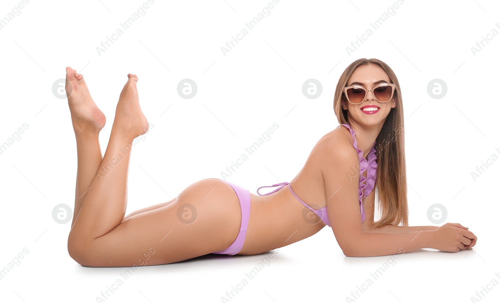 Photo of Pretty sexy woman with beautiful slim body in stylish bikini lying on white background