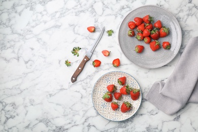 Flat lay composition with ripe red strawberries on marble background