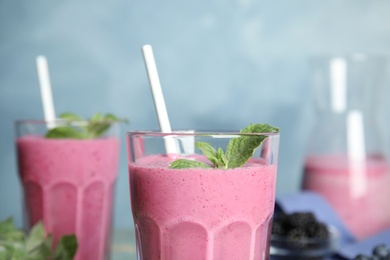 Photo of Tasty fresh milk shake with mint in glass, closeup