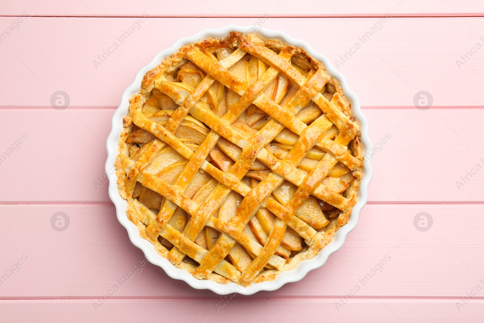 Photo of Tasty homemade quince pie on pink wooden table, top view