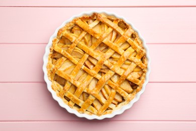 Photo of Tasty homemade quince pie on pink wooden table, top view