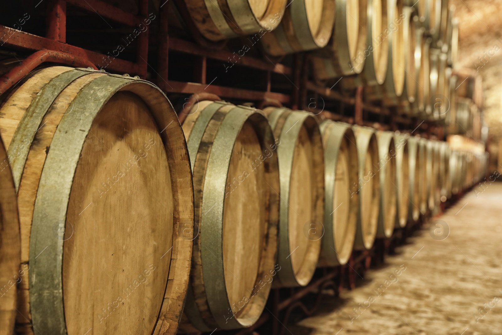 Photo of Large wooden barrels in wine cellar, closeup