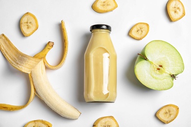 Photo of Flat lay composition with bottle of juice on white background