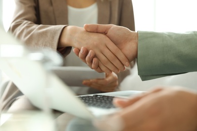 Business partners shaking hands after meeting, closeup