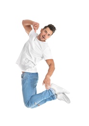 Photo of Young man in stylish jeans jumping on white background