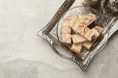 Photo of Tasty chocolate halva on light grey table, top view. Space for text