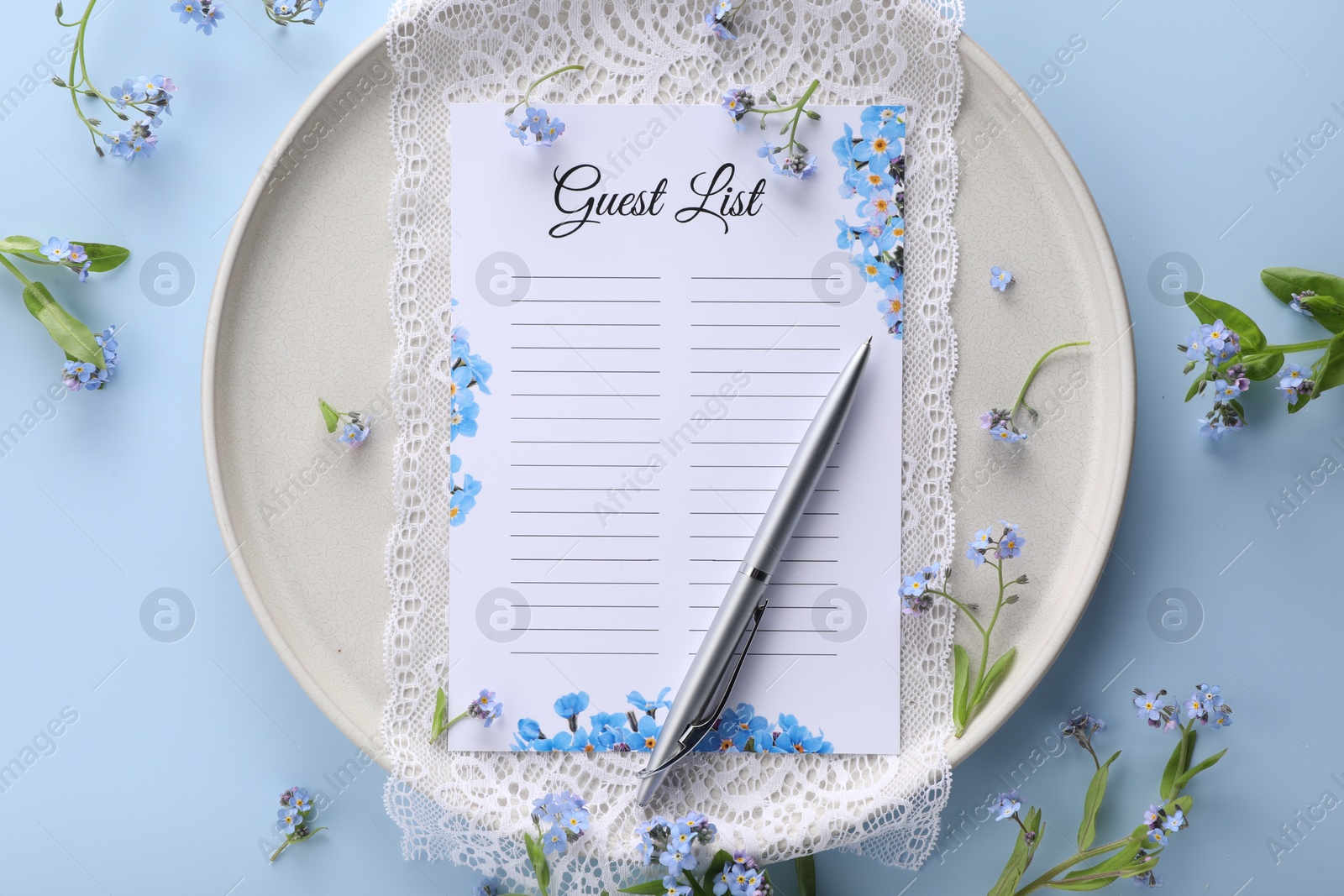 Photo of Plate with guest list, pen, lace and flowers on light blue background, flat lay. Space for text