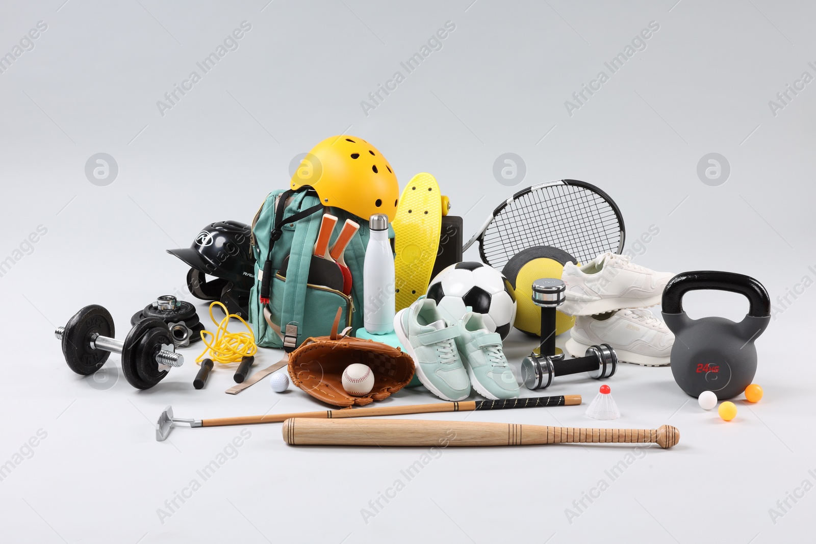 Photo of Many different sports equipment on light grey background