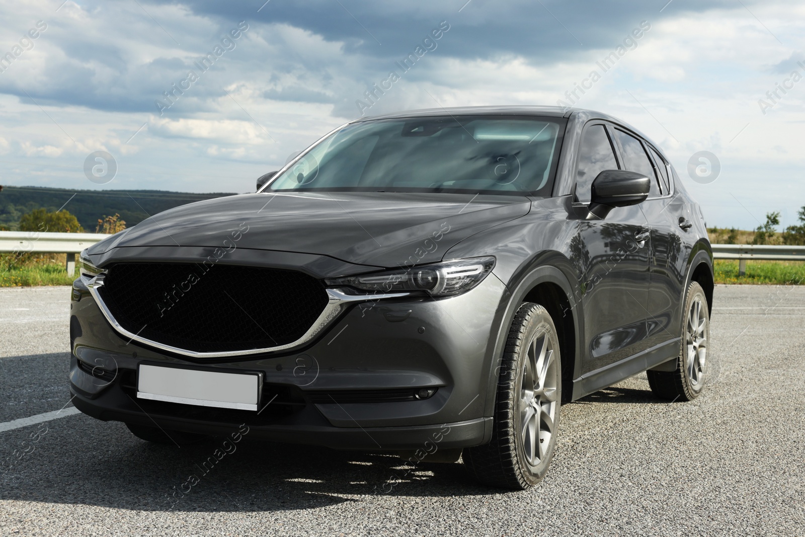 Photo of New black modern car on asphalt road