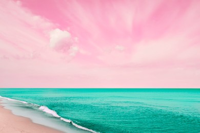 Image of Fantastic pink sky over turquoise ocean and sandy beach