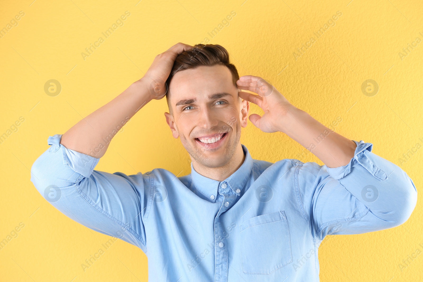 Photo of Portrait of young man with beautiful hair on color background