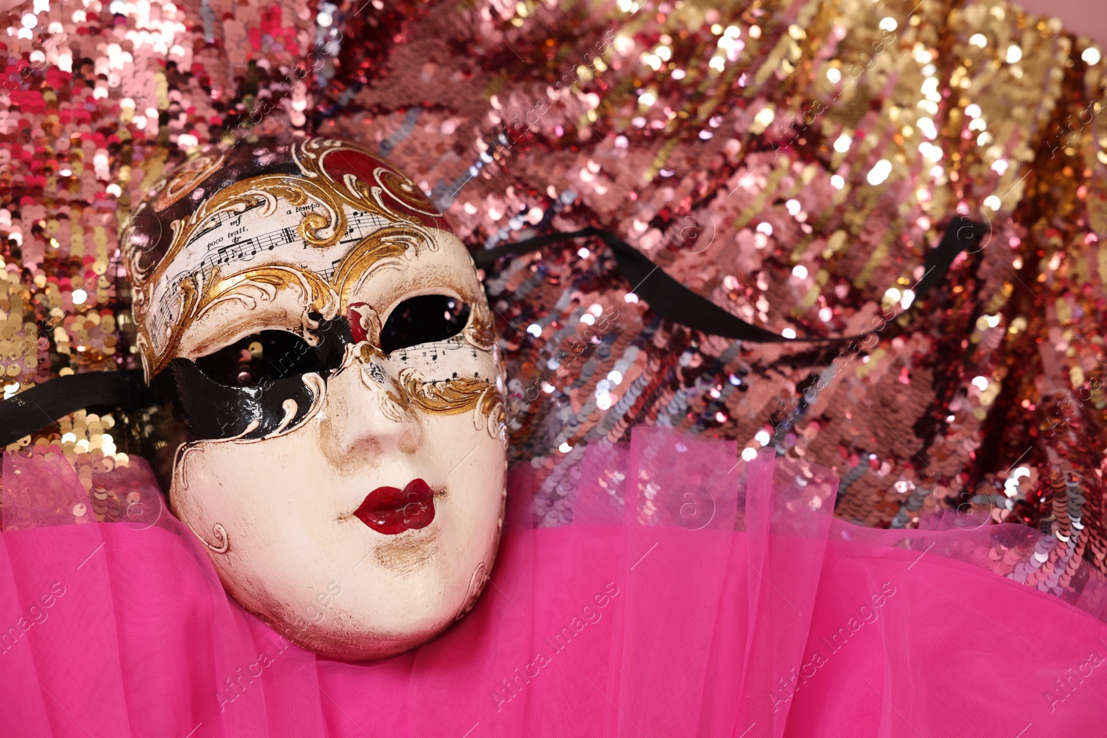 Photo of Carnival mask and beautiful pink costume with sequins, above view