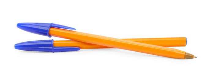 New orange plastic pens isolated on white
